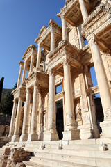 Fototapeta premium beautiful facade with columns of Library of Celsus in archaeological site Ephesus in Turkey under clear blue sky