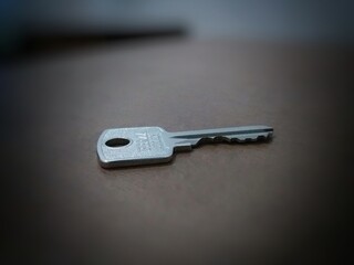 A key tucked away on the brown table