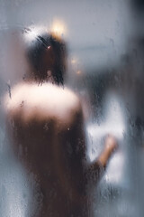 Man taking shower, view from behind. Hygiene concept.