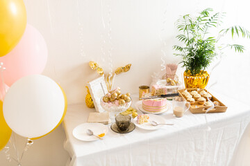 Table with leftovers after birthday with coffee, cake, cupcakes