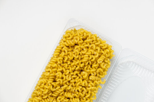 Close up of several types of dry pasta in a plate on white background