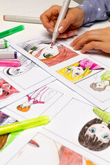 An artist draws a storyboard of an anime comics book. Manga style. The designer animator draws with...