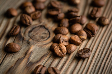 Coffee seeds on grunge wooden background close up. High quality photo