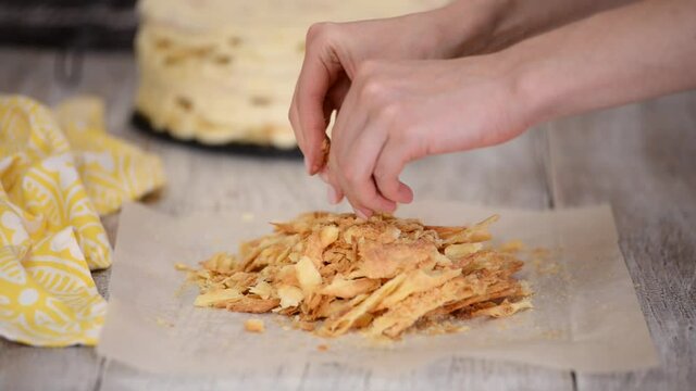 Woman hands making crumble for napoleon cake.