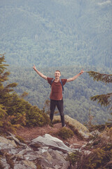 guy on a hike in the mountains. young guy in the mountains. hiking in the mountains