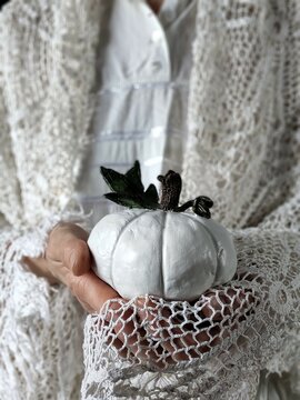 Rustic style person holding handmade white pumpkin
