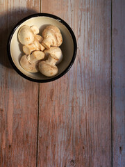 bowl with mushrooms on wooden top and space for writing
