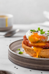 Toasted bread with poached egg, ham and onion for cooking benedict egg on white background. English...