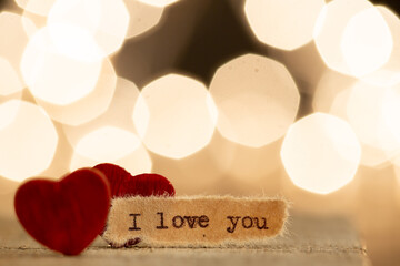 Valentine's Day greetings concept. Little red wooden heart and text I love you close up. Valentines...
