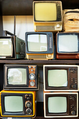 Many retro television. vintage old TV is colorful multi-row. Seeing the past. Pattern wall of  old Antique television (TV)