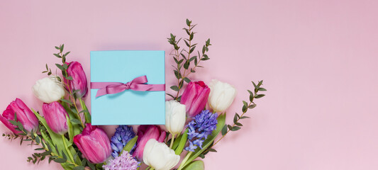Bouquet and gift box pink background