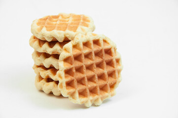 Belgian waffles on a table. holiday cookies on a white background. fresh baking concept. sweet desserts on a light texture