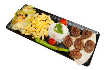 Grilled meatballs on black plate