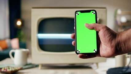 Old television with grey blank screen on home background living room, using smartphone with chroma key. Close-up of vintage tv on kitchen table, nostalgia. - Powered by Adobe