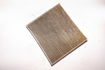 reverse side of the car cabin filter turned black from dirty air and stopped passing air, selective focus