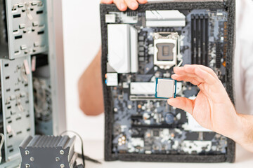 hand of repairman with a processor. professional services. 