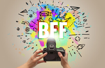 Close-up of a hand holding digital camera with abstract drawing