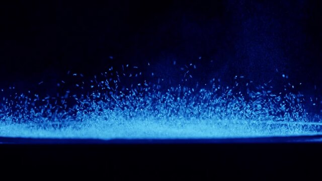 Acoustic sound system close-up, flying spices. Loud music volume macro shooting. Professional disco studio equipment subwoofer. Playback of musical stereo system, vibration.