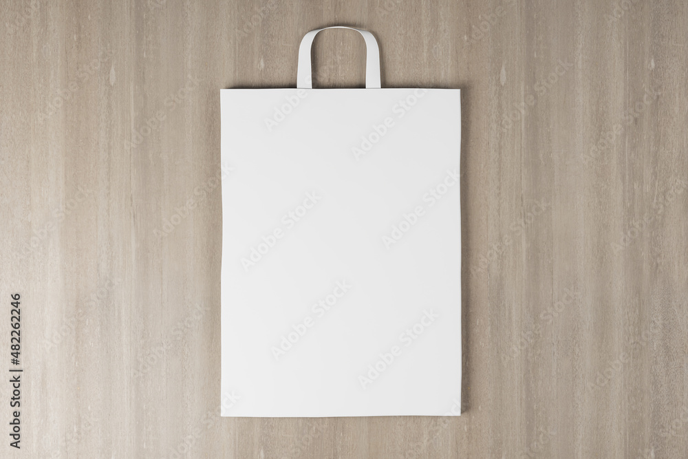 Aufkleber close up of empty white paper bag on wooden background. mock up place for your advertisement or logo