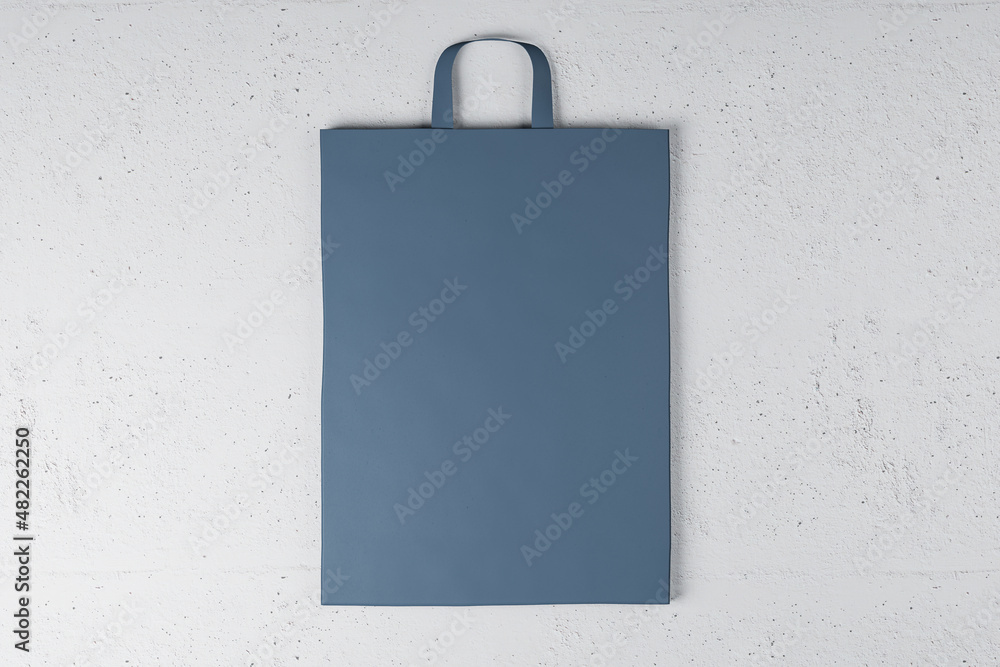 Poster close up of blue paper bag on white background. mock up place for your advertisement or logo. 3d ren