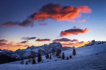 Pink clouds over a blue scenery at sunrise in Passo Falzarego, an alpine pass near Cortina d'Ampezzo, Dolomites, Italy