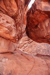 Overton, Nevada, USA - February 24, 2010: Valley of Fire. Closeup of kissing huge red rock boulders at narrow canyon.