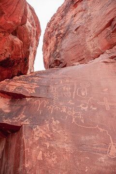 Overton, Nevada, USA - February 24, 2010: Valley of Fire. Closeup of ancient pictographic messages scratched on red roc surfaces in canyon. 
