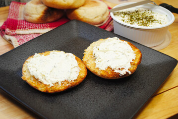Toasted English Muffin Served Topped with Spreadable Cheese, Garlic and Herbs