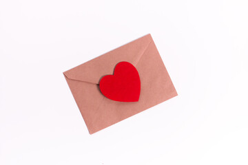 Paper envelope with blank white note mockup inside and Valentines hearts on pink background. Flat lay, top view. Romantic love letter for Valentine's day concept.
