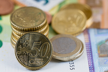 Close-up of euro coins on euro bills of different values 