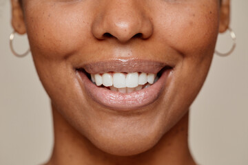 Close up portrait of young African-American woman smiling at camera demonstrating beautiful natural...
