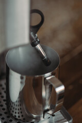 Steaming Milk with Espresso Machine. Coffee Shop Lifestyle. Steam Rising Against Dark Background.