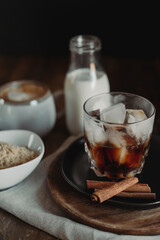Iced Brown Sugar Oat Milk Latte Ingredients. Process of Making Iced Coffee. Moody Coffee Shop Lifestyle. Iced Coffee Flat Lay with Copy Space. Stir and Pour.
