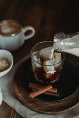 Iced Brown Sugar Oat Milk Latte Ingredients. Process of Making Iced Coffee. Moody Coffee Shop Lifestyle. Iced Coffee Flat Lay with Copy Space. Stir and Pour.
