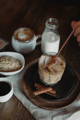 Iced Brown Sugar Oat Milk Latte Ingredients. Process of Making Iced Coffee. Moody Coffee Shop Lifestyle. Iced Coffee Flat Lay with Copy Space. Stir and Pour.
