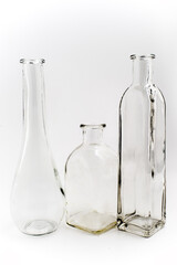 three empty glass vintage bottles on a white background