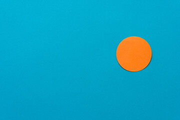 orange circle isolated on a blue background with blank space