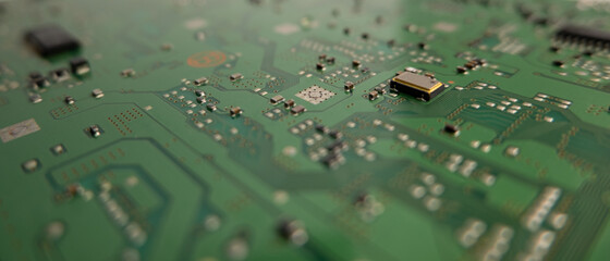 Components on a green circuit board. Close up, shallow depth of field background.