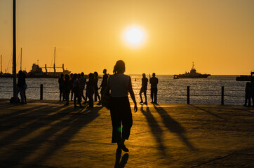 people on the beach at sunset