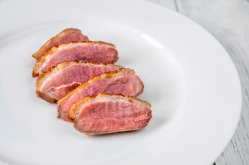 Sliced fried duck breast on the plate
