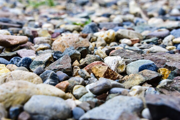 Small stones near the sea with selective focus. Blurred background, summer wallpaper