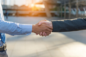 Fototapeta premium Team Business Partners shaking hands together to Greeting Start up small business in meeting room. Shakehand teamwork partners at modern office handshake together. Business mergers and acquisitions