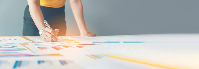 Banner Businesswoman reading financial graph charts business info with computer laptop. Panorama Women hands using laptop on office desk. Hands of business woman working office with copy space