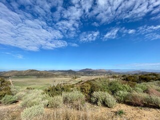 Wide view across scrubland towards mountains in Thousand Oaks area,  CA, seen from Point Mugu State...