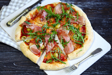 Selective focus. Pizza jamon and arugula. Italian pizza.