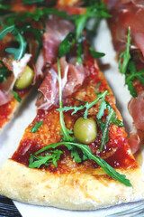 Selective focus. Pizza jamon and arugula. Italian pizza.