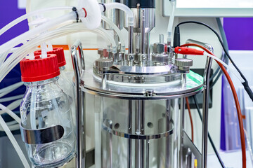 Glass laboratory fermenter. Glass fermenter close-up. Fermenter for biological research. Equipment...
