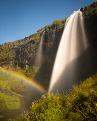 rainbow over waterfall