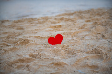 Fototapeta premium red heart in the sand on the beach