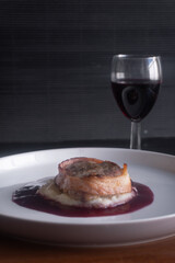 Filet mignon with bacon, cheese and a red wine sauce.